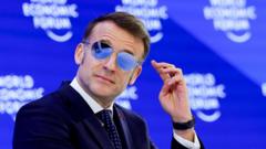 Why is Emmanuel Macron wearing sunglasses indoors at Davos?