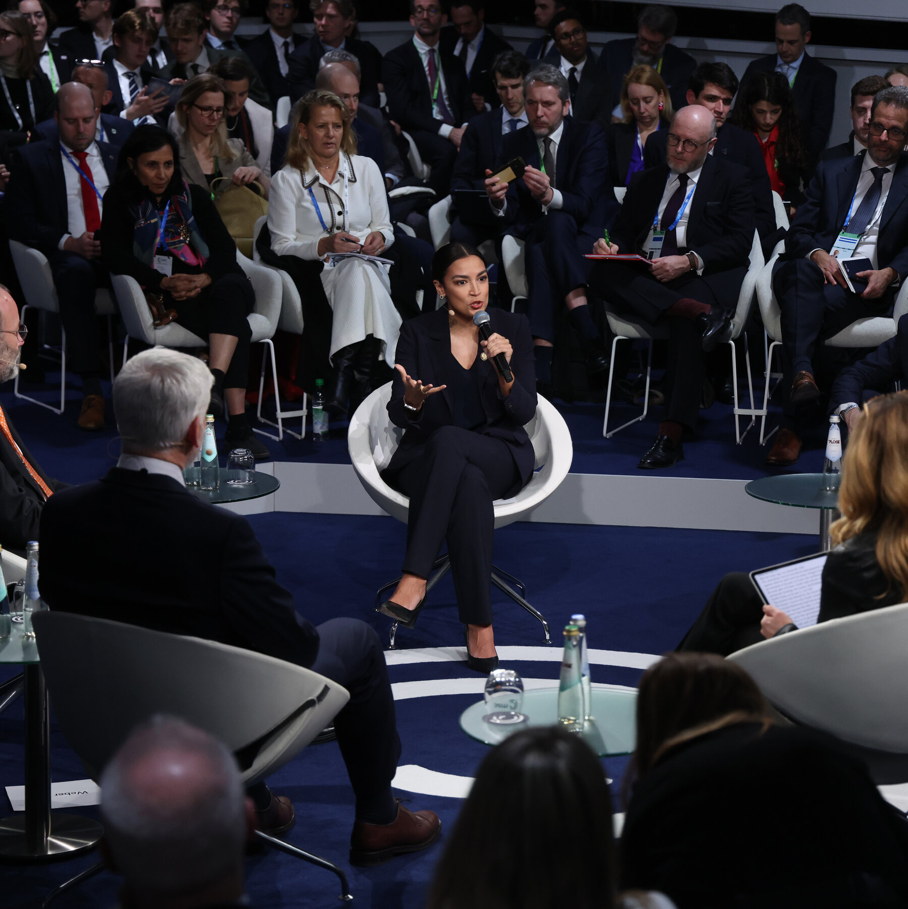 Ocasio-Cortez Offers a Working-Class Vision in Munich, With a Few Stumbles