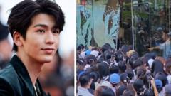 Watch: Fans break glass door trying to see Netflix star
