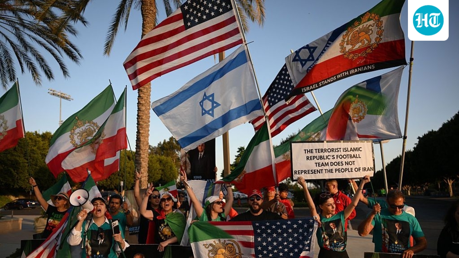 Iran football team lands in Los Angeles shortly before US peace agreement, to protests displaying anti-regime banners