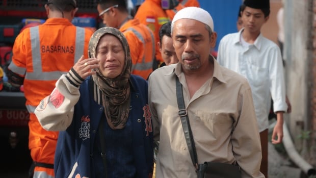 Nearly 100 children hurt, several feared dead and dozens trapped after Indonesian school collapses