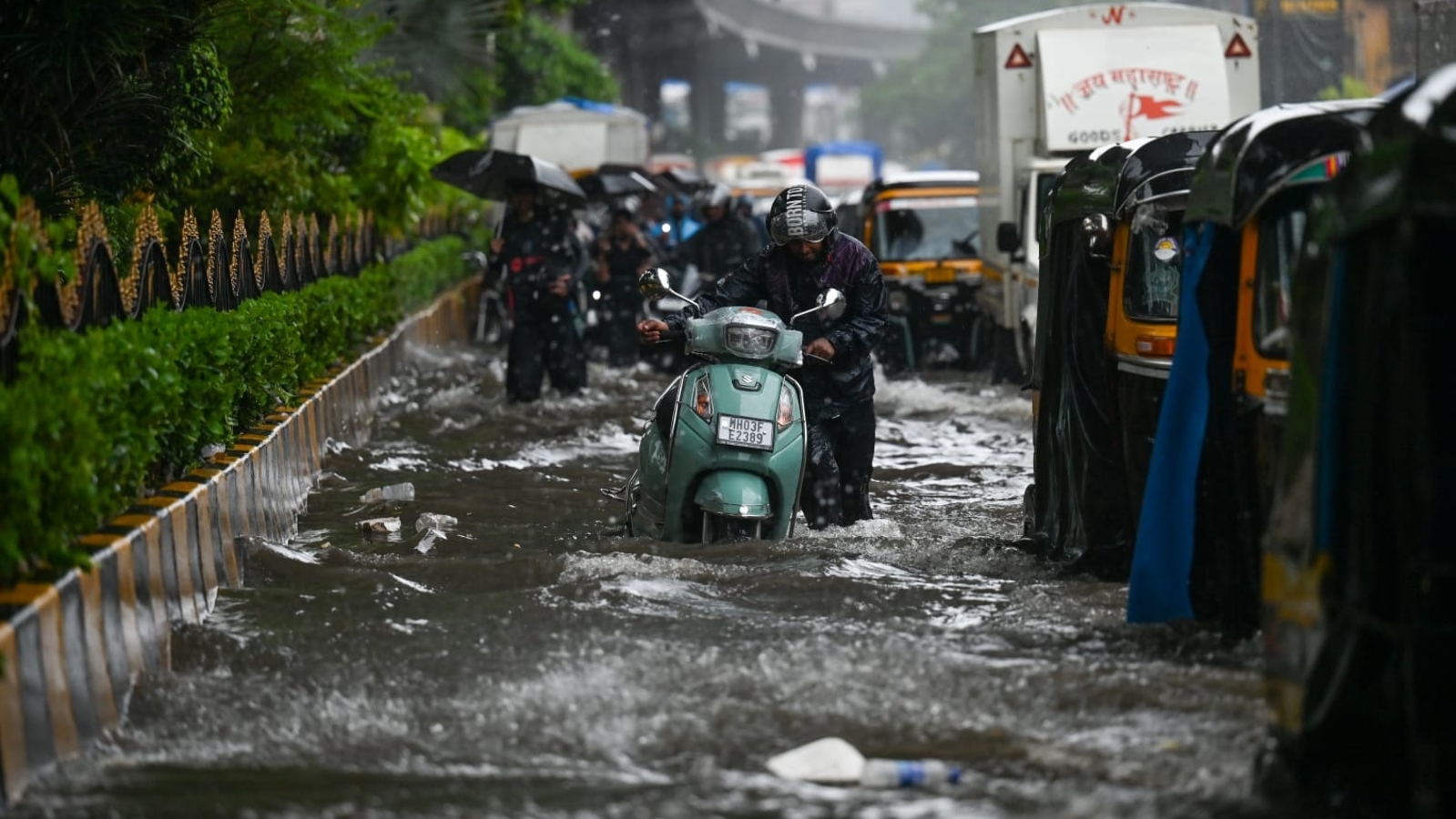 Mumbai rain LIVE: Flights, local trains hit as rain chokes Mumbai; vehicle falls into caved-in road